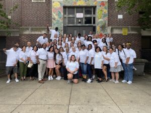 Staff of Fell Elementary in front of the steps of Fell Elementary