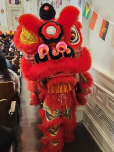 A lion dancer in red up close.