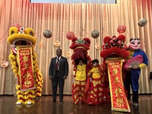 Principal Ashe with the lion dancer performers.