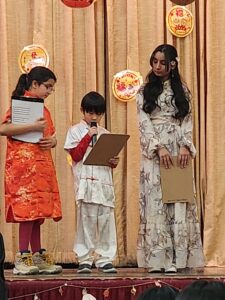 3 students reading New Year's Day poems