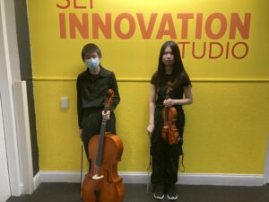 2 Fell students backstage at All City Middle School Orchestra.